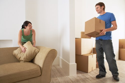 Removal team estimating furniture volume for a local house move